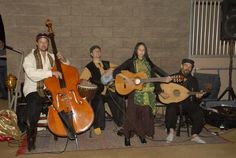 a group of people sitting around each other with guitars and musical instruments in front of them