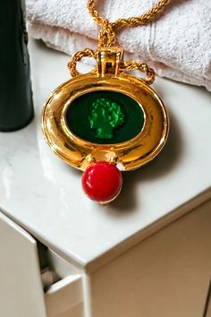 "Chain is 22\". Unmarked. Pendant can be removed. Chain is gold." Red Enamel Brooch Jewelry, Gold Enamel Necklaces With Cabochon, Gold Enamel Necklace With Cabochon, Red Enamel Jewelry With Large Pendant, Red Cameo Necklace For Gift, Red Cameo Jewelry Gift, Medallion Necklace With Brooch As Gift, Perfume Necklace, Cabochon Necklace