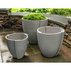 three cement planters sitting next to each other