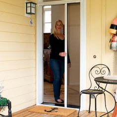 a woman standing in the doorway of a house