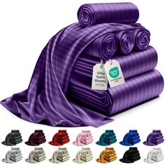 various colors of yoga mats stacked on top of each other with tags attached to them