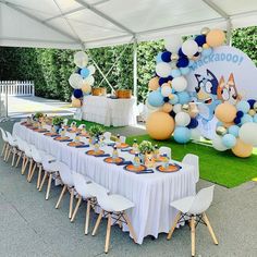 an outdoor party setup with balloons and decorations