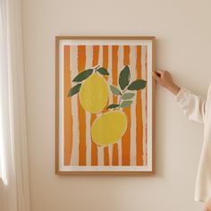 a woman standing next to a painting on the wall