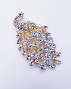 Ready to Add Some Sparkle to Your Special Day? Discover Our Medium Rhinestone Peacock Brooch – The Ultimate Bridal Pin! Elevate your wedding attire with this exquisite Gold Crystal Brooch, adorned with mesmerizing rhinestones. Whether it's for your gown, sash, or tuxedo, this versatile accessory adds a touch of elegance and charm. Crafted with precision and care, this brooch boasts a medium size, perfect for making a statement without overpowering your ensemble. Its dimensions of 3.75 x 1.75 inc Elegant Peacock Brooches For Wedding, Elegant Peacock-colored Brooches For Wedding, Wedding Brooch With Peacock Design, Elegant Wedding Brooch With Peacock Design, Elegant Peacock Design Brooch For Wedding, Elegant Peacock Color Wedding Brooches, Elegant Peacock Design Wedding Brooch, Peacock Colored Wedding Brooch Jewelry, Elegant Party Brooch With Peacock Design