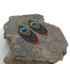 Peacock earrings Feather earrings Beaded earrings Statement earrings Boho earringsPeacock wedding Long dangle earrings Multi color earrings Fringe earrings Peacock jewelry Feather jewelry Peacock blue Peacock green Earrings with peacock eyes are made of selected Czech beads according to their own author's pattern. I chose this combination of colors to try to recreate the depth of the unique beauty of these peacock feathers. Length of the Earrings - 4 inch 100% handmade Czech seed beads. Shipping Bohemian Blue Jewelry With Peacock Design, Blue Bohemian Jewelry With Peacock Design, Handmade Peacock Wedding Jewelry, Handmade Peacock Colored Jewelry For Weddings, Bohemian Peacock Earrings As Gift, Bohemian Peacock Design Earrings For Wedding, Bohemian Peacock Earrings For Gift, Peacock Bohemian Earrings As Gift, Elegant Handmade Peacock Jewelry