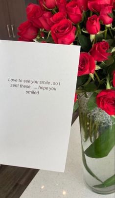 a vase filled with red roses sitting next to a card that says love to see you smile, i sent these hope you smiled