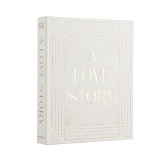 a love story book in white with gold lettering