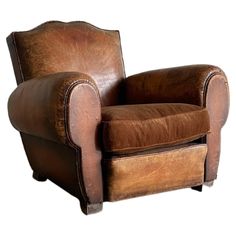 a brown leather chair on a white background