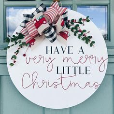 a sign that says have a very merry little christmas hanging on the front door window