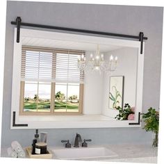 a bathroom mirror with a chandelier hanging above it