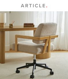 an office chair sitting on top of a rug next to a desk with a lamp