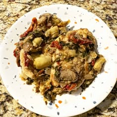 a white plate topped with food on top of a counter