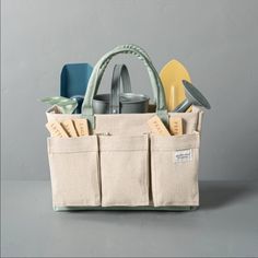 a tool bag filled with tools on top of a gray table next to scissors and other items