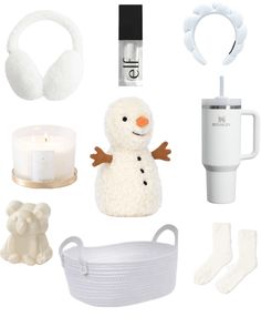 the contents of a white christmas gift set including a snowman, headphones, candles and other items