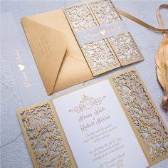 the wedding stationery is gold and white