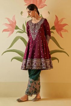 Wine anarkali with floral gotta, silken threads and mirror work, zari embroidery. Paired with embroidered pant and embroidered dupatta.
Components: 3
Pattern: Embroidered
Type Of Work: Floral
Neckline: Round
Sleeve Type: Three quarter
Fabric: Silk, Lining: Crepe
Color: Wine
Other Details: 
Attached lining
Scallop border dupatta
Note: All the jewellery worn by the model is for styling purpose only
Occasion: Wedding - Aza Fashions Dola Silk Kurta With Mirror Work For Reception, Reception Dola Silk Kurta With Mirror Work, Reception Dola Silk Salwar Kameez With Mirror Work, Dola Silk Salwar Kameez With Mirror Work For Reception, Reception Salwar Kameez With Mirror Work In Dola Silk, Embroidered Dola Silk Churidar For Reception, Dola Silk Churidar With Zari Work For Receptions, Traditional Jamawar Dress With Mirror Work, Art Silk Anarkali Set With Mirror Work For Reception