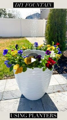 a flower pot sitting on top of a patio next to a yard with the words, diy fountain using planters