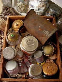 an old wooden box filled with lots of different types of jars and other things in it