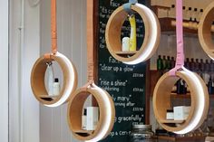 several circular wooden shelves hanging from the ceiling