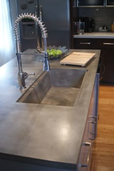 a stainless steel sink and counter top in a kitchen