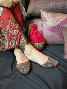 Item Details. A pair of women's antique Indian embroidered slippers which are from Bengal in the 1800's.  I bought them in Delhi in the 1980's and they have been in my collection since.  The uppers on this pair are fashioned in silk velvets in jewel colours of magenta and emerald green. They are encrusted with silver gilt embroidery, some of which is raised and padded, depicting stylised floral motifs.  Edged in a narrow purple ribbon, these slippers are so lovely!  Measurements. 10 inch (25 cm) toe to heel. 4 inch (10 cm) across widest point on the toe. Condition: Very Good In good condition for an item of this era. The lacquered soles show signs of wear around the edges and the soles have some scuff marks. There is some wear to the velvet on the toes and sides of the shoes. Further Notes Victorian Slippers, Traditional Embroidered Round Toe Slippers, Vintage Full Fur Slippers, Vintage Ballet Slippers, Traditional Embroidered Slip-on Slippers, Traditional Multicolor Slip-on Slippers, Embroidered Slippers, Jewel Colors, Purple Ribbon