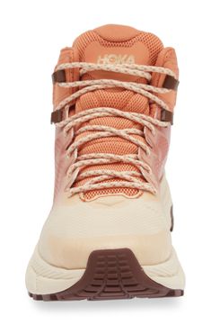 the back view of a women's hiking shoe with laces and an orange color