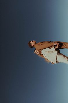 a man flying through the air while riding a skateboard on top of his head