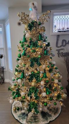 a green and gold christmas tree in a living room