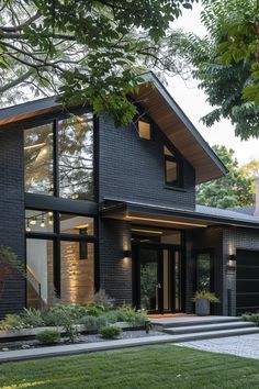 a modern house with black siding and windows