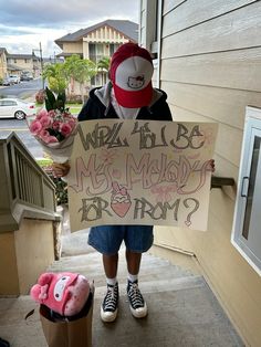 a person holding a sign with writing on it