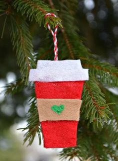 a cup ornament hanging from a christmas tree