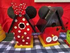 two wooden houses with minnie mouse ears on them