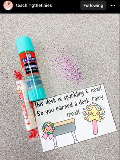 a card with some writing on it next to a pen and glue bottle that says, this desk is sparkling & neat so you learned a desk fairy