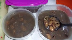 two plastic containers filled with food on top of a table