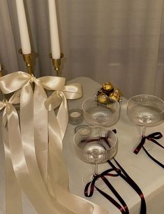 the table is set with candles and glass dishes