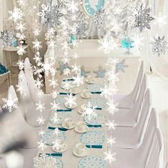 the table is set with snowflakes and plates