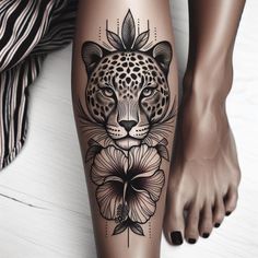 a woman's leg with a leopard and flower tattoo on it