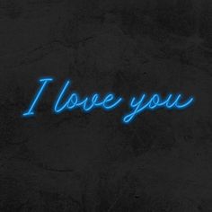 the word i love you written in blue neon lights on a black concrete wall with dark background