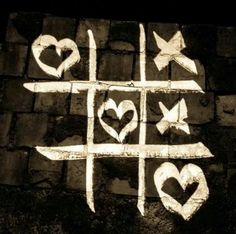 the words love written in white chalk on a blackboard with hearts and arrows drawn on it