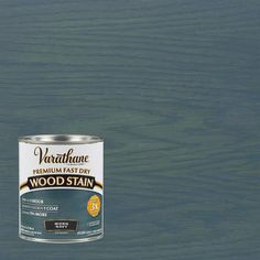 a can of varnishe wood stain sitting on top of a wooden floor in the ocean