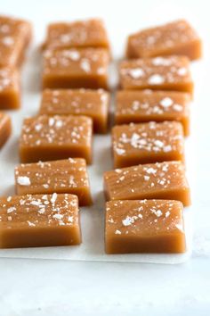 several pieces of caramel fudge on a white surface