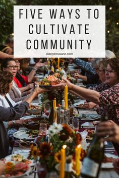 a group of people sitting around a table with food