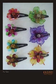 six colorful hair clips with flowers on them