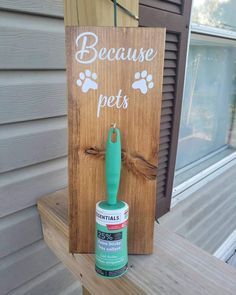 a wooden sign that says because pets with a green paint roller