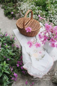 a basket sitting on top of a table next to flowers