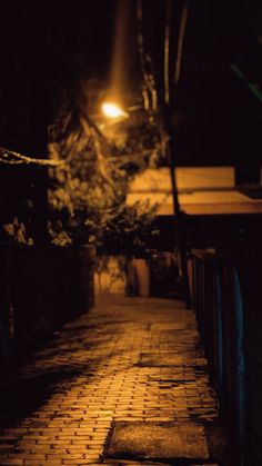 an empty street at night with the light on