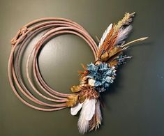 a rope with flowers and feathers attached to it