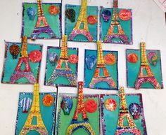 many pictures of the eiffel tower are made out of paper and colored pencils