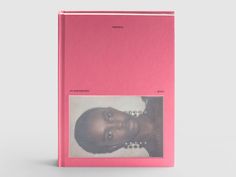 a pink book with an image of a woman's face on it