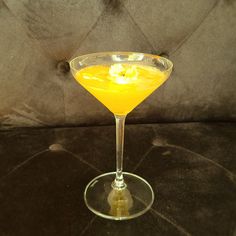 a yellow drink sitting on top of a table